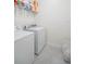 Bright laundry room, washer, dryer, and shelving at 9474 Sanders Park Pl, Seffner, FL 33584