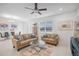 Bright living room with light leather sofas, glass coffee table, and large TV at 9474 Sanders Park Pl, Seffner, FL 33584