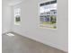 Simple bedroom with gray carpeting and large windows at 1017 Signet Dr, Apollo Beach, FL 33572