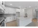 Modern kitchen with white shaker cabinets, quartz countertops and black hardware at 1017 Signet Dr, Apollo Beach, FL 33572