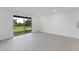 Bright and airy living room with tile floors and sliding glass doors leading to the backyard at 1017 Signet Dr, Apollo Beach, FL 33572