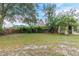 Backyard with grass, trees, and a shed at 4212 Empire Pl, Tampa, FL 33610