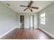 Spacious bedroom with wood flooring, ceiling fan, and access to bathroom at 4212 Empire Pl, Tampa, FL 33610