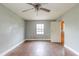 Simple bedroom with wood flooring and access to the kitchen at 4212 Empire Pl, Tampa, FL 33610