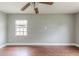 Simple bedroom with wood floors and a window at 4212 Empire Pl, Tampa, FL 33610