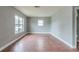 Bright living room featuring wood flooring and large windows at 4212 Empire Pl, Tampa, FL 33610