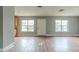 Large living room with wood flooring and multiple windows at 4212 Empire Pl, Tampa, FL 33610