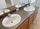 Double vanity bathroom with dark countertop at 706 Fern Leaf Dr, Ruskin, FL 33570