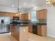 Kitchen with island, stainless steel appliances, and wood cabinets at 706 Fern Leaf Dr, Ruskin, FL 33570