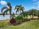 Landscaped yard with a scenic lake view at 706 Fern Leaf Dr, Ruskin, FL 33570