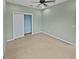 Spacious bedroom with carpeted floor and large closet at 8955 Garden Party Dr, Land O Lakes, FL 34637