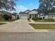 One-story house with attached garage, landscaping, and a paved driveway at 8955 Garden Party Dr, Land O Lakes, FL 34637