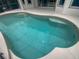 Inviting kidney shaped swimming pool at 8955 Garden Party Dr, Land O Lakes, FL 34637