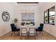 Bright dining room with glass table, modern chandelier and hardwood floors at 988 47Th N Ave, St Petersburg, FL 33703