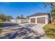 Two-car garage with concrete driveway and fenced yard at 988 47Th N Ave, St Petersburg, FL 33703