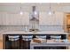 White kitchen with quartz countertops and a large island with seating at 988 47Th N Ave, St Petersburg, FL 33703