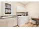 Clean laundry room with washer, dryer, and cabinets at 988 47Th N Ave, St Petersburg, FL 33703