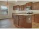 Eat-in kitchen with island and wood cabinets at 2428 Roanoke Springs Dr, Ruskin, FL 33570