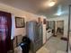 Kitchen area with refrigerator and partial view of dining area at 4727 Murray Hill Dr, Tampa, FL 33615