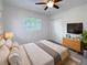 Bright bedroom with large window, ceiling fan, and ample closet space at 907 N Palm Dr, Plant City, FL 33563