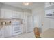 Bright white kitchen features granite countertops and stainless steel appliances at 1648 La Gorce Dr, Venice, FL 34293