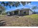 House back view with grassy yard and raised garden beds at 12600 Jillian Cir, Hudson, FL 34669