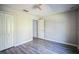 Bright bedroom with grey flooring and an open doorway at 12600 Jillian Cir, Hudson, FL 34669