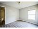 Light bedroom with wood-look floors and large window at 12600 Jillian Cir, Hudson, FL 34669