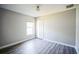 Well-lit bedroom, featuring wood-look floors and window at 12600 Jillian Cir, Hudson, FL 34669