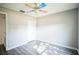 Bright bedroom with grey wood flooring and ceiling fan at 12600 Jillian Cir, Hudson, FL 34669