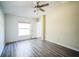 Well-lit bedroom, wood-look floors and ceiling fan at 12600 Jillian Cir, Hudson, FL 34669