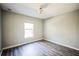 Simple bedroom with wood-look floors and window at 12600 Jillian Cir, Hudson, FL 34669