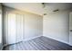 Bright bedroom with grey flooring and double door closet at 12600 Jillian Cir, Hudson, FL 34669