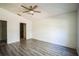 Spacious bedroom featuring wood-look floors and ceiling fan at 12600 Jillian Cir, Hudson, FL 34669