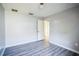 Simple bedroom with grey flooring and an open doorway at 12600 Jillian Cir, Hudson, FL 34669