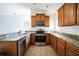 Spacious kitchen with granite countertops and wooden cabinetry at 12600 Jillian Cir, Hudson, FL 34669