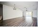 Bright living room featuring hardwood floors and ceiling fan at 12600 Jillian Cir, Hudson, FL 34669