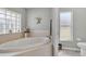 Bathroom featuring a large garden tub and separate shower at 13474 Tune Ln, Spring Hill, FL 34609