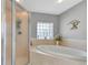 Relaxing bathroom with soaking tub, shower, and updated fixtures at 13474 Tune Ln, Spring Hill, FL 34609