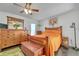 Spacious bedroom with wooden furniture and orange bedding at 13474 Tune Ln, Spring Hill, FL 34609