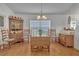 Charming dining room featuring wooden drop leaf table and hutch at 13474 Tune Ln, Spring Hill, FL 34609