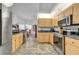 Bright kitchen with stainless steel appliances and light wood cabinets at 13474 Tune Ln, Spring Hill, FL 34609