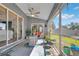 Relaxing screened porch with ceiling fan, wicker furniture, and view of backyard at 13474 Tune Ln, Spring Hill, FL 34609