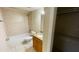 Well-maintained bathroom with tub, toilet, and storage at 2860 Somerset Park Dr # 203, Tampa, FL 33613