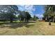 Spacious grassy area with mature trees, perfect for relaxation or recreation at 2860 Somerset Park Dr # 203, Tampa, FL 33613