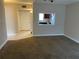 Spacious living room with carpet and kitchen pass-through at 2860 Somerset Park Dr # 203, Tampa, FL 33613