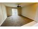 Spacious living room with carpet and sliding glass door leading to a balcony at 2860 Somerset Park Dr # 203, Tampa, FL 33613