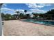 Community pool with brick patio and surrounding landscaping at 2860 Somerset Park Dr # 203, Tampa, FL 33613