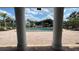 View of the community pool through columns, showing a relaxing atmosphere at 2860 Somerset Park Dr # 203, Tampa, FL 33613