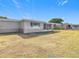 Backyard view of home with screened porch at 6941 Twilite Dr, Port Richey, FL 34668